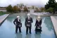 Suited performers from Ocean Rebellion, wearing blindfolds a
