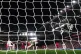 Liverpool goalkeeper Alisson Becker saves a penalty from Wes