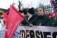 An ambulance worker holds a Unite flag on the picket line ou