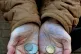 A pensioner holding some change in her hand