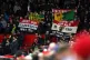 Manchester United fans in the stands hold up flags in protes