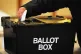 A voter placing a ballot paper in the ballot box