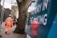 A construction worker walks past HS2 signage near to the pro
