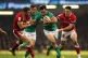 Wales' Dan Biggar (left) tackles Ireland's Hugo Keenan durin