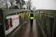 A police officer walks past a missing person appeal poster f