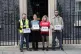 Representatives from Renters' Reform Coalition hand in a pet