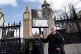 A man holding a placard outside the Houses of Parliament in 