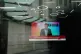 A screen showing a news report seen through the windows of t