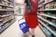A shopper walking through the aisle of a supermarket