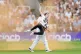 England's Johnny Bairstow carrying a Just Stop Oil protester