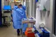 A nurse putting on full PPE on a ward for Covid patients at 