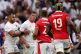 England's Owen Farrell is held back from Wales' Dan Biggar d
