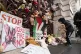 A child adds a teddy bear to the pile outside Britain's Fore