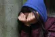 A teenage girl with her head in her hands (picture posed by 