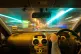 a man driving a car in traffic at night