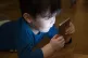 PIC CAP Catch them young: an iPhone addict Pic: Andi Graff/W