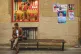 SPAIN DECIDES: A man checks his phone next to a wall with el