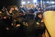 Turkish police officers detain a woman during a protest mark