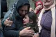 Samira Edwan, 40, left, mother, and Yusra, 10, sister, cry d