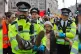 Police carry away an XR protester from Oxford Street in cent