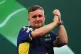 Luke Littler celebrates after winning his match against Ian 