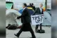 THE WORD IS OUT: A City worker walks past an anti-capitalist