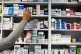 A pharmacist stocks shelves at a chemist, November 16, 2009