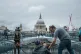 A man gives change to a homeless person in central London