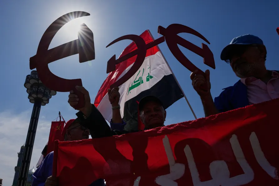 Supporters of the Iraqi Communist Party holds a symbolic hammer and sickle as they take part in the May Day celebration in Baghdad, Iraq, Friday, May 1, 2026
